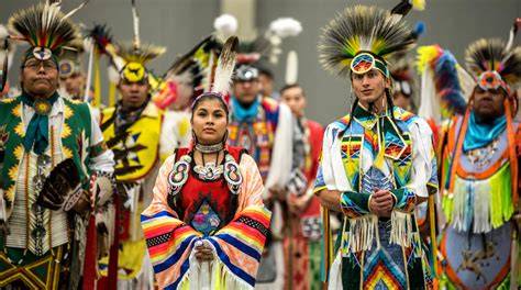A group of Indigenous people gathered at a historical site to commemorate an important event.