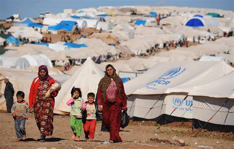 A group of Syrian refugees living in tents, illustrating the humanitarian crisis.