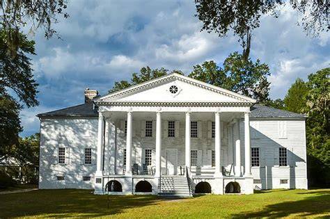 A scenic view of Hampton Plantation's landscape with explanations of its historical context regarding slavery.