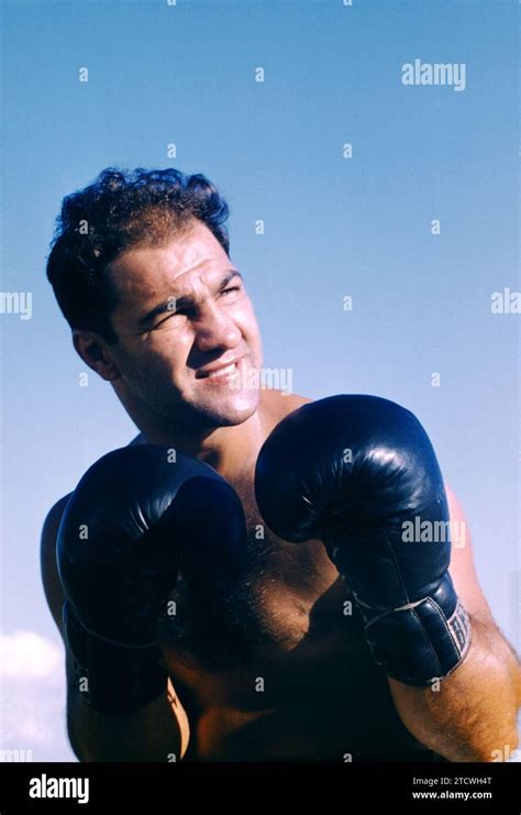 A determined boxer training in a gym, visibly motivated by the spirit of Rocky.