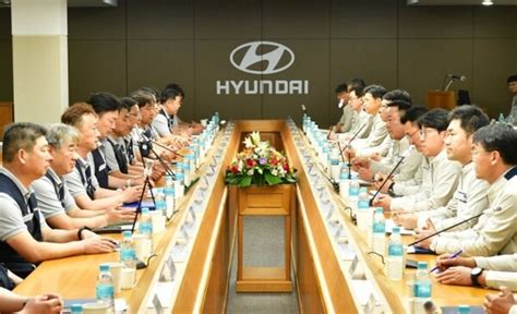 Union representatives negotiating terms with Hyundai management.