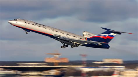 A Tupolev Tu-154 aircraft in the livery of an Eastern European airline on the tarmac.