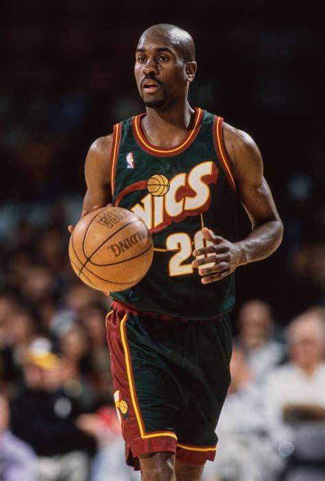 Gary Payton dribbling the basketball on the court.