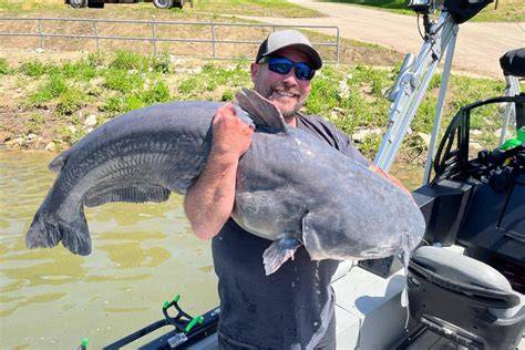 A group of anglers celebrates after a successful fishing trip with record catches.