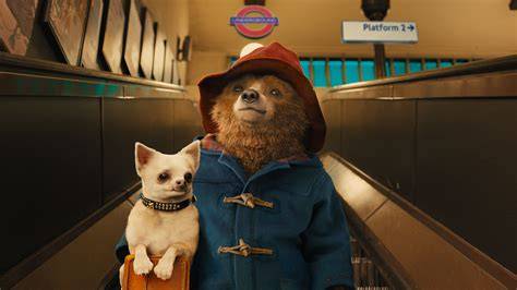 A still from the Paddington film showing the bear in a lively city setting.