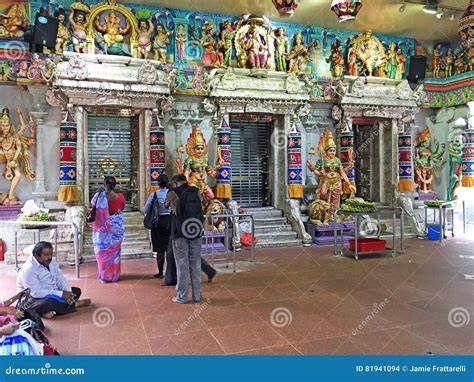 A group of Hindu worshippers engaged in prayer inside a temple in Greece.