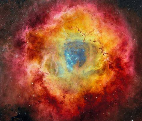 A scene depicting new stars forming in the dense regions of the Rosette Molecular Cloud.
