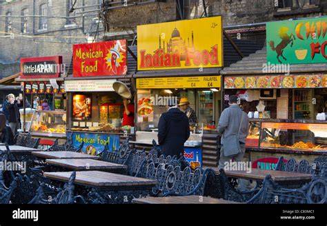 A busy scene of visitors enjoying food at various stalls in Camden Market.