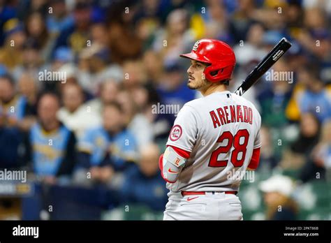 Nolan Arenado taking a swing at the plate during a game.