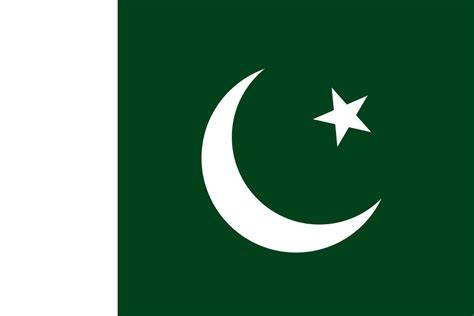 The flag of Pakistan prominently shown at a public event, surrounded by people.