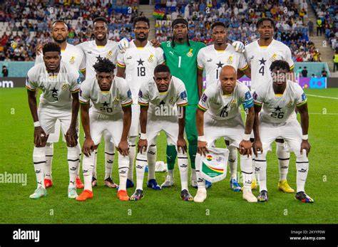 Ghana national football team players posing with the Africa Cup of Nations trophy