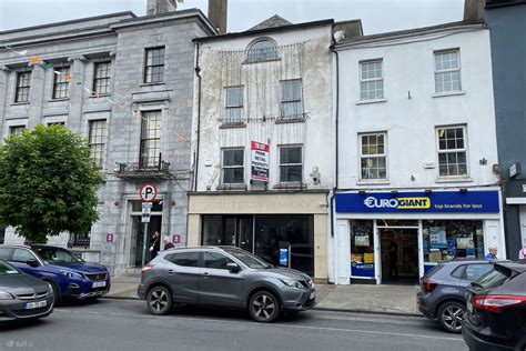 A busy retail store located on Main Street in Clonmel with customers walking by.