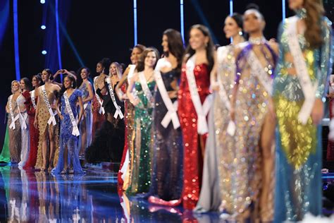 Contestants walking the runway in elegant evening gowns during the Miss Universe pageant.