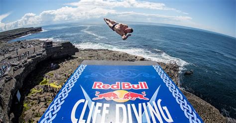 Safety barriers and designated areas are set up for spectators at a cliff diving event.