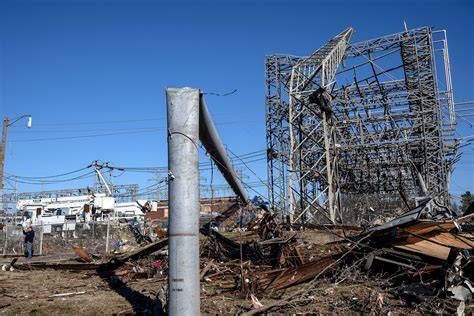 Rescue workers and residents inspecting the damage to buildings and infrastructure after a tornado.