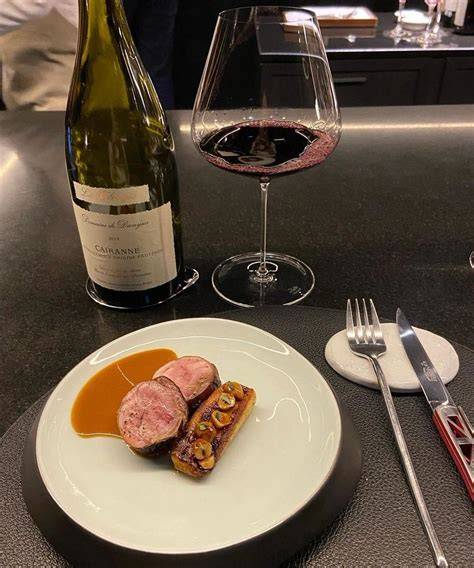 A glass of Danish red wine served alongside grilled pork chops.