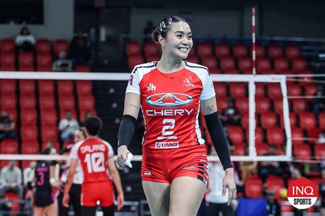 Aby Maraño practicing her volleyball skills with a coach
