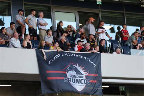 A group of fans discussing the London Broncos fixtures for the upcoming season.