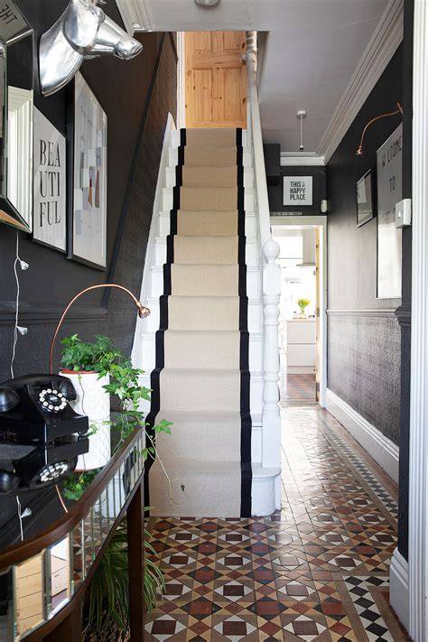 A narrow hallway featuring dog-leg stairs that save space.
