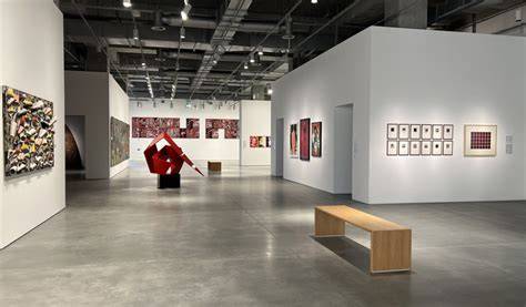 A busy exhibition showcasing Rolf Thiele's artwork in a modern gallery.