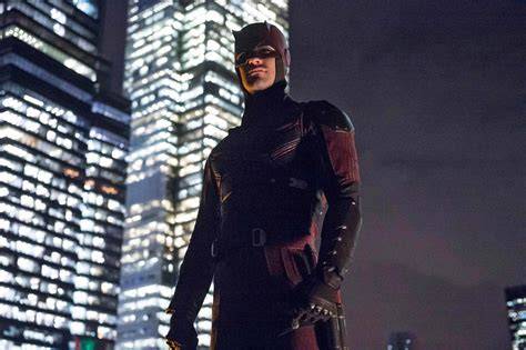 Daredevil, the blind superhero, leaping across rooftops in a cityscape.