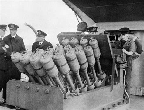 A historical photograph of a British destroyer using the Hedgehog weapon during a World War II battle.