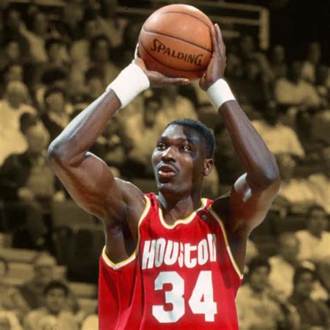Hakeem Olajuwon making a shot during a game.