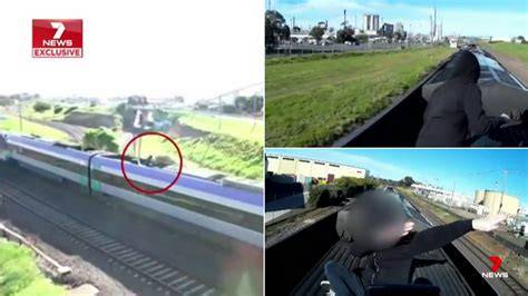 A train surfer receiving a ticket from an officer for illegal activity.