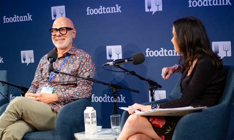 Attendees networking and sharing ideas at a Food Tank summit focused on sustainability.