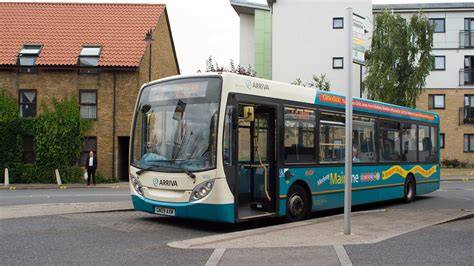 Passengers getting off an Arriva Southern Counties bus at a train station