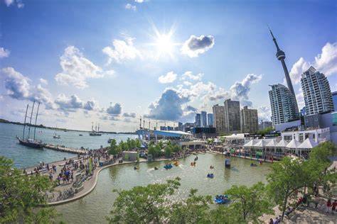 A lively outdoor summer festival with music and people at Harbourfront Centre.