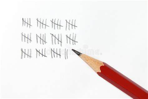 A close-up view of hands drawing tally marks with a pencil on paper.