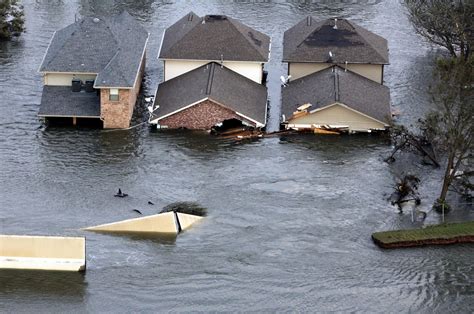 People cleaning up debris in their neighborhood after Hurricane Jeanne's destruction.