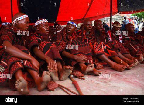 A group of individuals participating in a Bantu initiation ceremony with traditional garments and rituals.