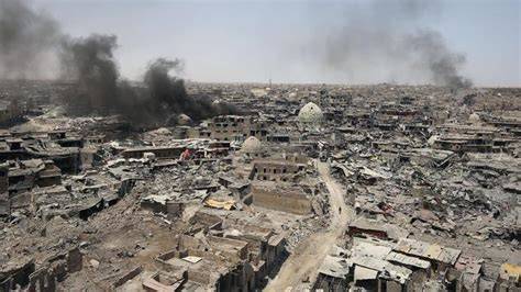 Iraqi forces moving through a city street during intense fighting in Mosul.