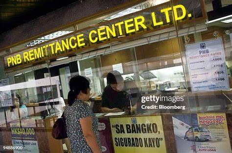 A Filipino worker at a remittance center sending money to family.