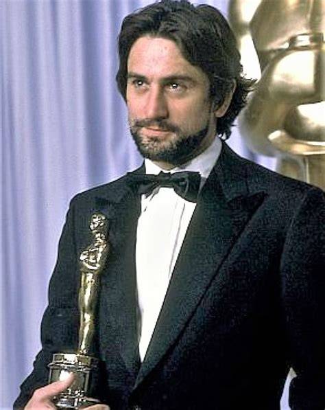 Robert De Niro posing with his Oscar trophy.