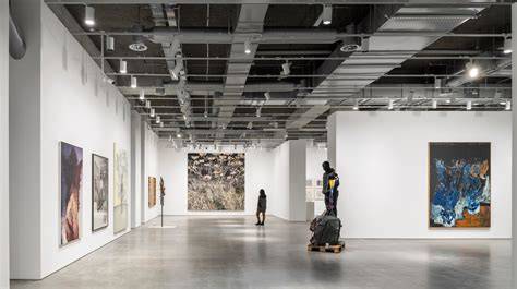 Visitors viewing Angela V. John's pieces during an exhibition opening.