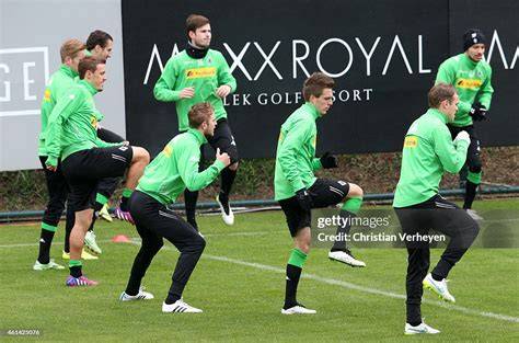 Borussia Mönchengladbach players training on the pitch during a practice session.