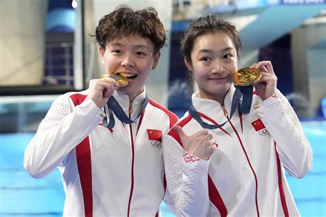 Chinese athletes proudly displaying their medals after a successful event at the Asian Games.