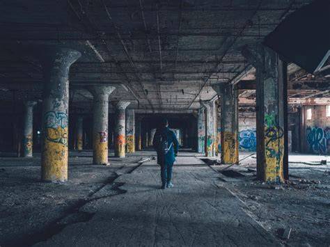 A solo adventurer carefully navigating through an abandoned site with caution.