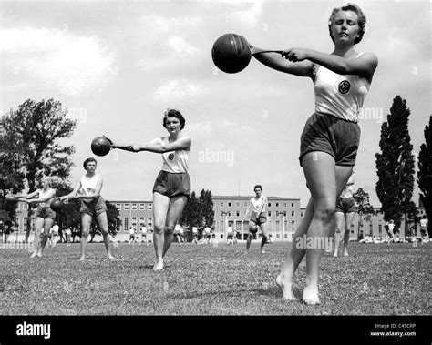Girls from the League of German Girls exercising in a park setting.